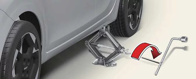 Raising a Kia Picanto with the jack until the tyre clears the ground