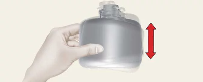 Shaking the sealant bottle before using the Kia Picanto Tyre Mobility Kit
